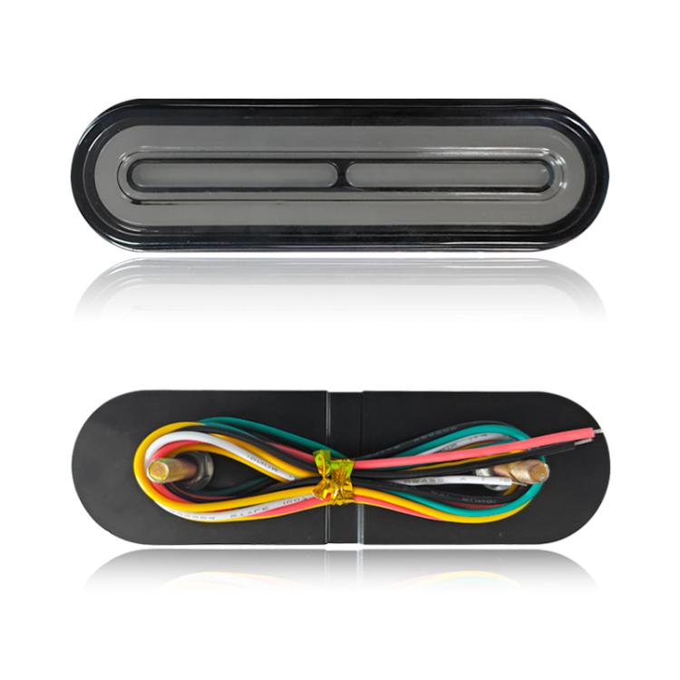 LED tail light with smoked lens and rear housing, showing wire harness