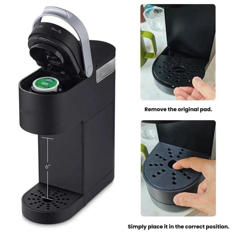 Black drip tray replacement being installed by hand on coffee maker base