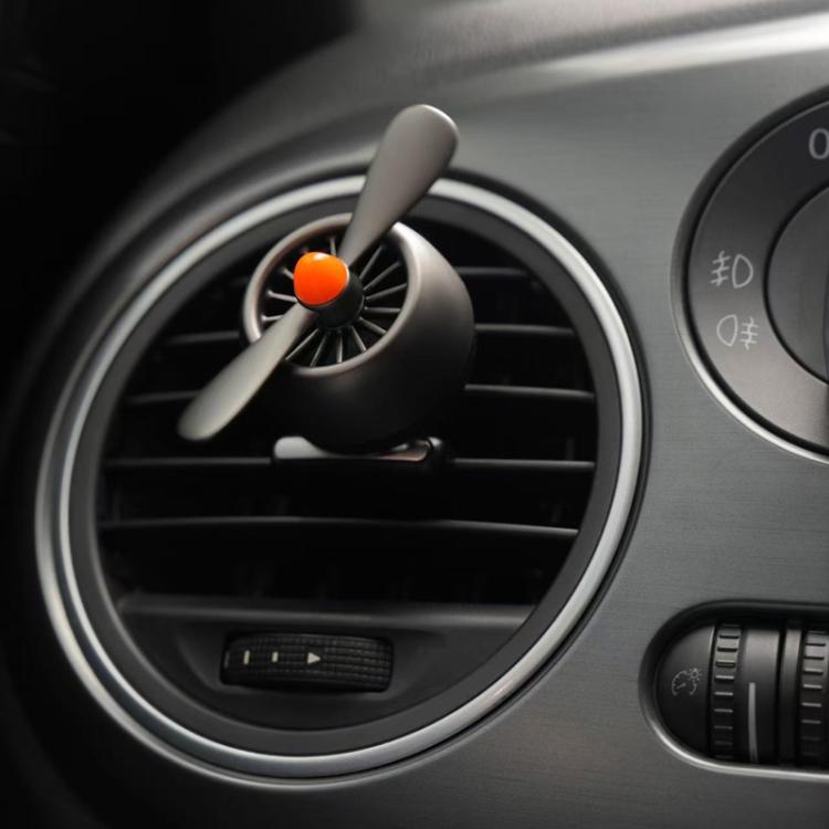 Car air vent air freshener ornament clipped in a round vent with orange top