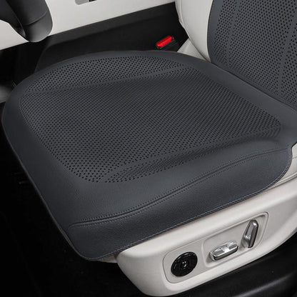 Black perforated front car seat cushion with breathable ventilation holes.