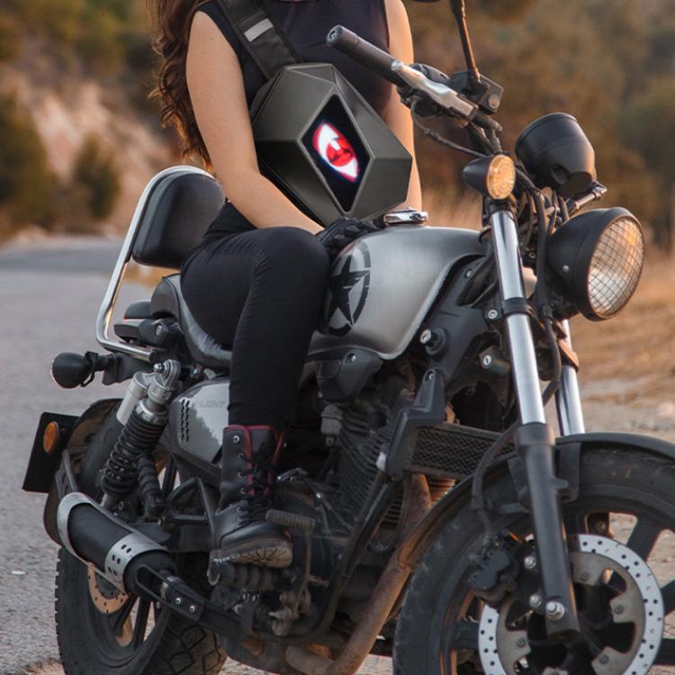 Motorcycle rider wearing black LED shoulder bag with lit front display screen