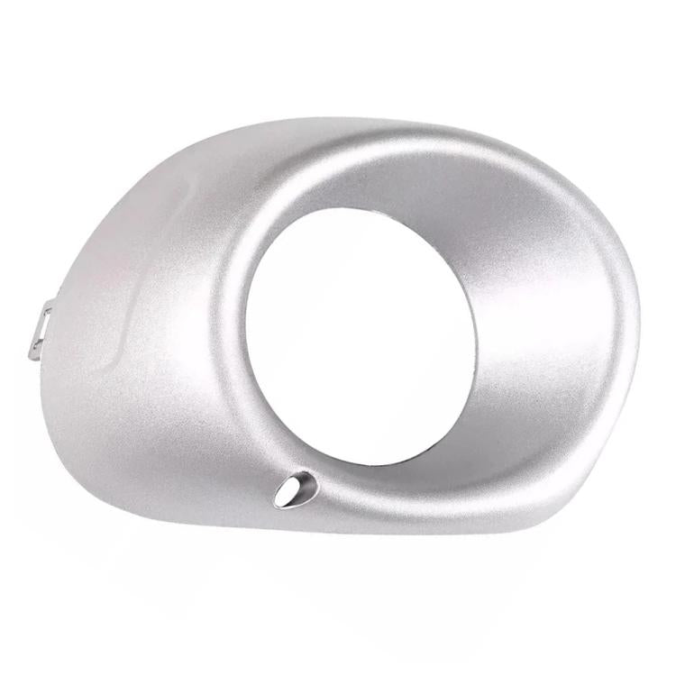Silver fog light bezel with circular opening and side mounting clip