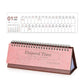 Pink 2026 mini desk calendar with spiral rings and flip stand, monthly grid Jan–Dec