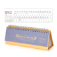 Blue 2026 mini desk calendar with spiral rings and flip stand, monthly grid Jan–Dec