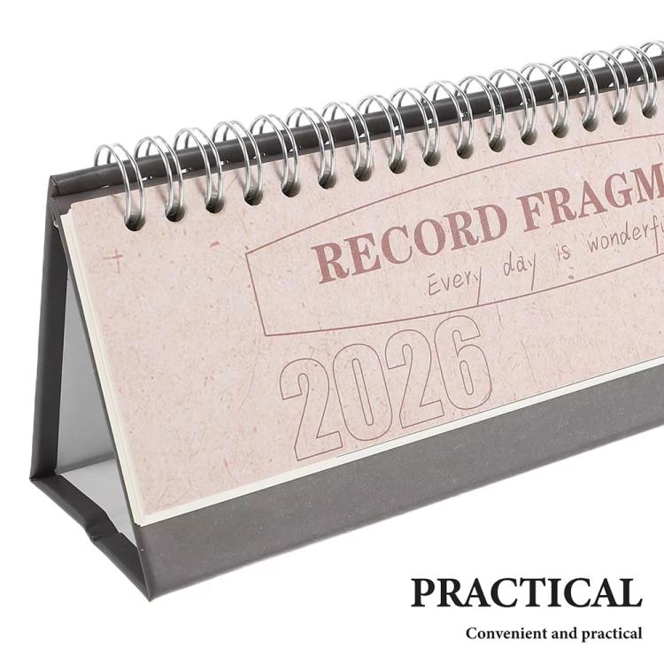 Close-up of beige 2026 mini desk calendar with spiral rings on flip stand