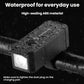 Waterproof black bicycle headlight with raindrop-splashed housing and front LED lens