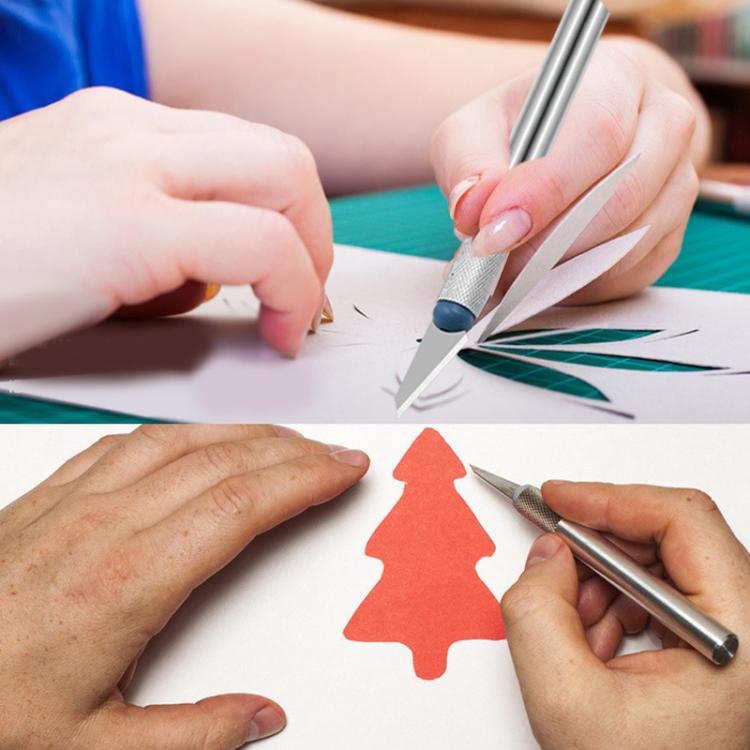 Metal engraving cutters with blue tips cutting decorative paper shapes