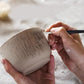 Pottery texture brush applying imprint lines to clay with a stainless steel needle head
