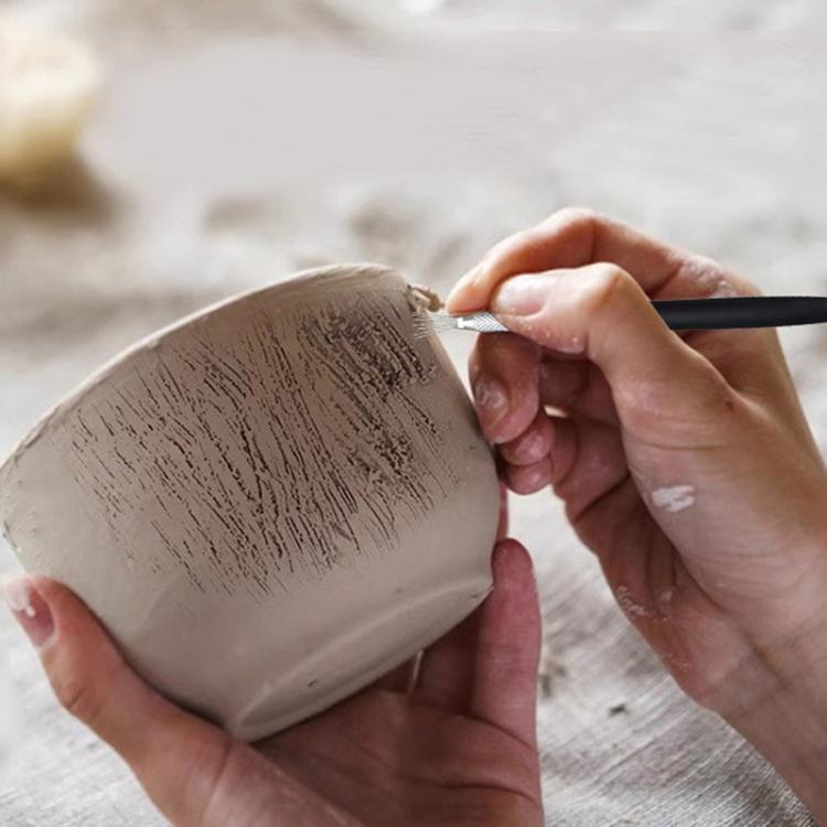 Pottery texture brush applying imprint lines to clay with a stainless steel needle head