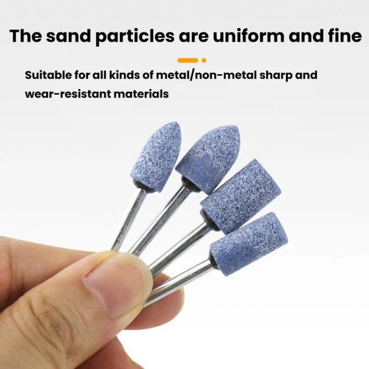 Hand holding blue abrasive sanding/polishing heads on metal shanks