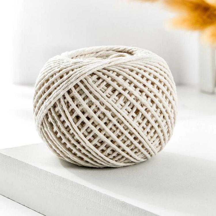 Cotton rope packaging thread spool in beige and white braided yarn