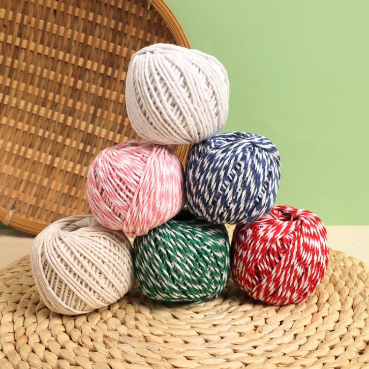 Mixed-color cotton rope packaging thread spools stacked together: white, pink, green, blue, red