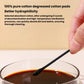 Hand holding a black cotton swab tip above a small cup of liquid