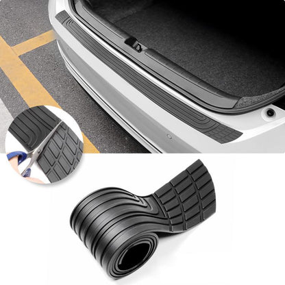 Car trunk bumper guard strip, black textured rubber installed along rear bumper edge
