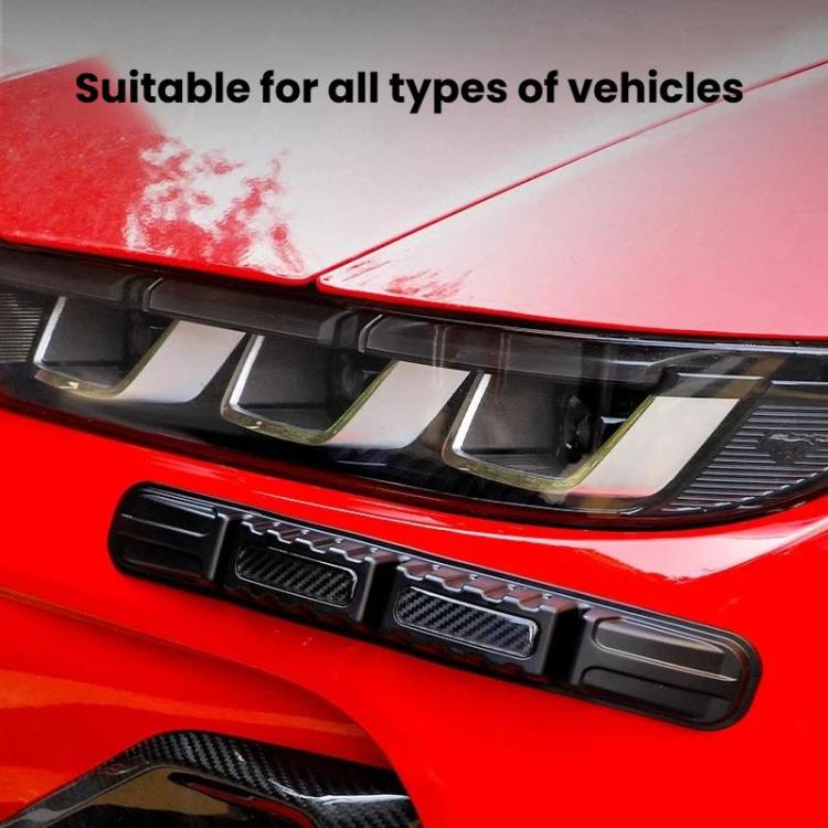 Black bumper protection strip with carbon-fiber texture installed on vehicle bumper.