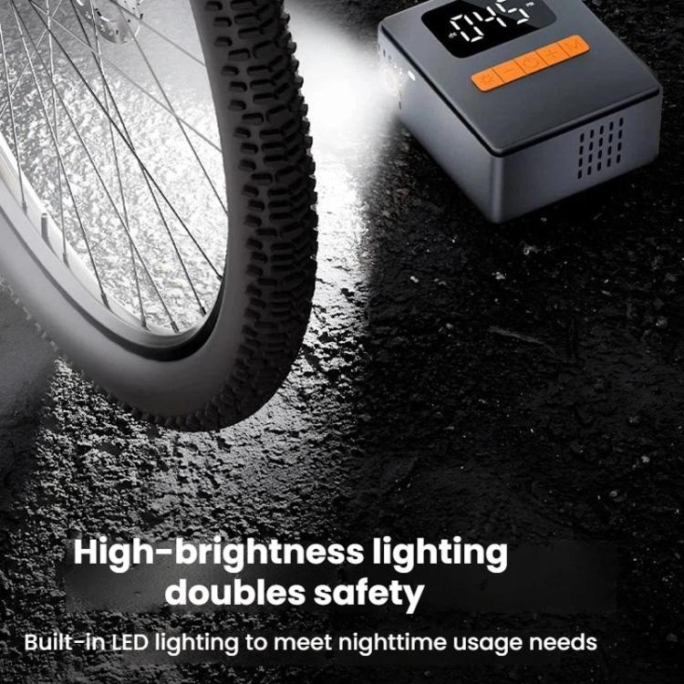 Portable tire inflator with integrated LED light mounted near a vehicle tire