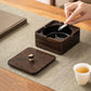 Walnut wood square ashtray with brass bowl, lid open, cigarette ash being cleaned