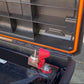 Installed car battery ceramic fuse with red cover and bolt terminals in fuse holder