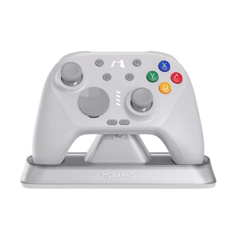 White mechanical game controller on a charging stand base with colorful face buttons