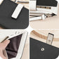 Black compact wallet close-up: snap tab, card slots, and zipper coin pocket