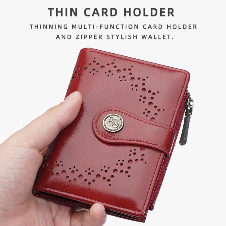 Red women’s short wallet with perforated pattern, snap strap, and side zipper