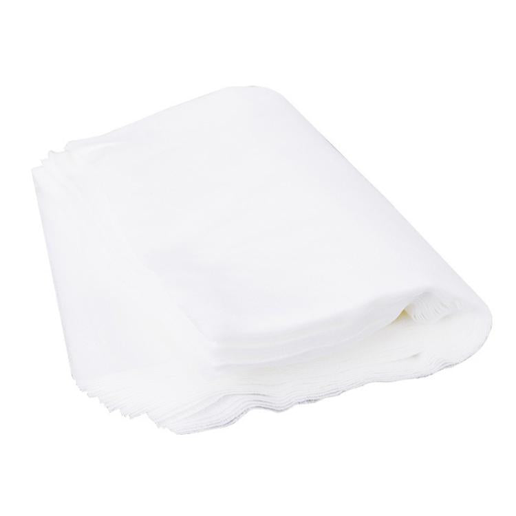 Stack of white disposable nail dust filter pads