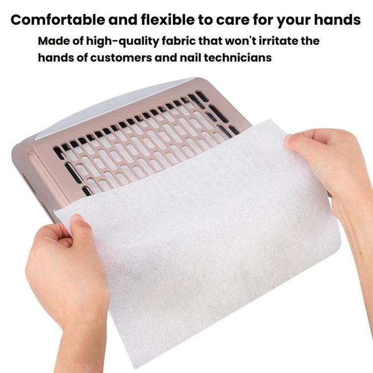 Hand placing a white nail dust filter pad over nail vacuum opening