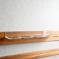 Clear acrylic wall mount hockey puck storage rack with mounting on wooden surface