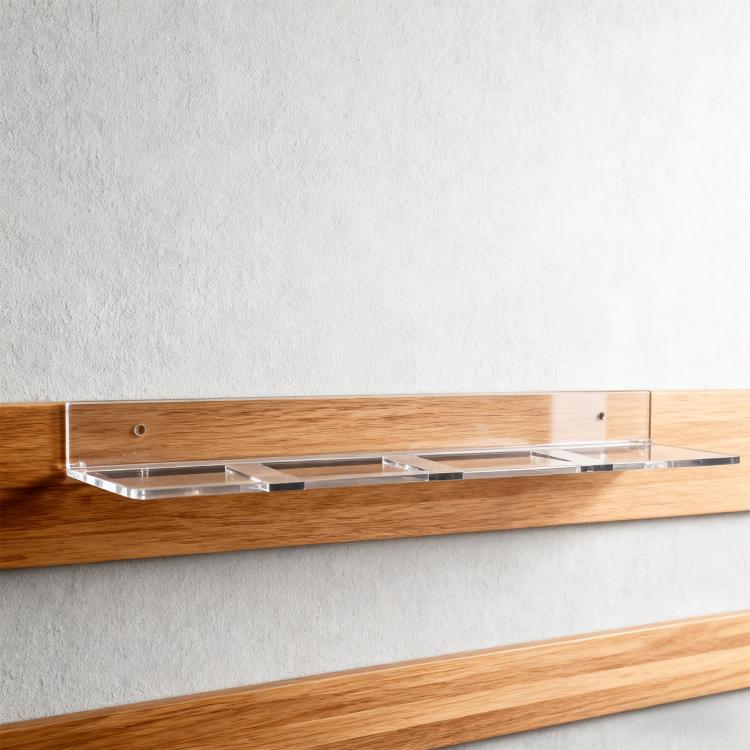 Clear acrylic wall mount hockey puck storage rack with mounting on wooden surface