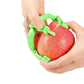 Green hand-crank peeler held in hands while peeling a red apple