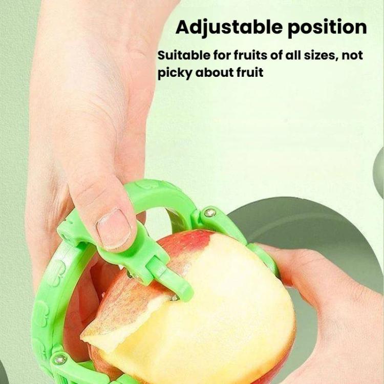 Green hand-crank apple peeler adjusting position on a red apple half