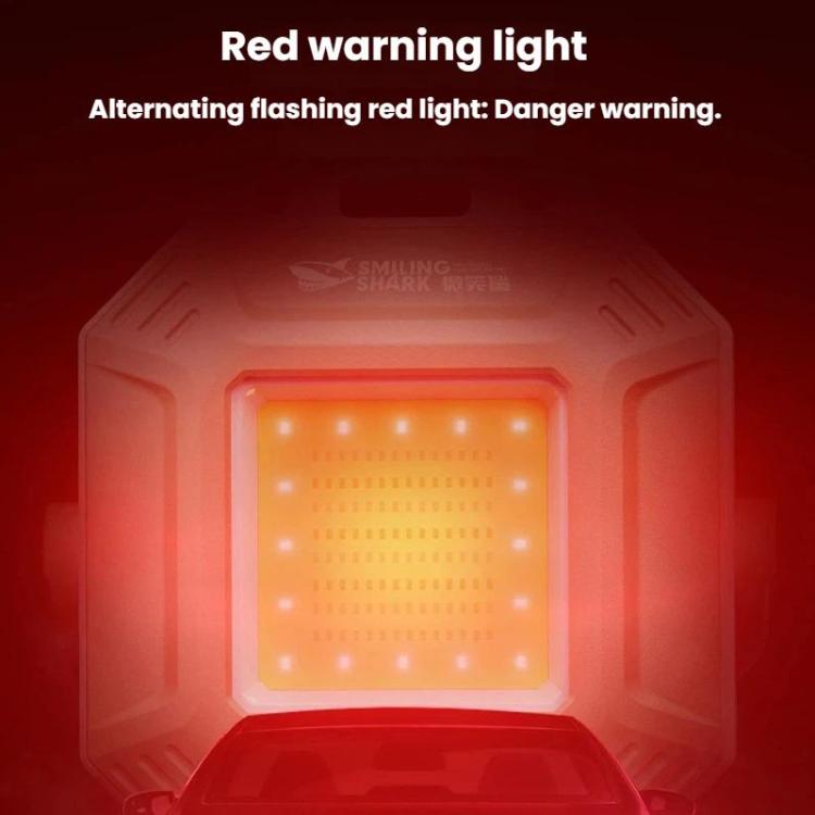 Mini work light with red warning light glowing inside square panel