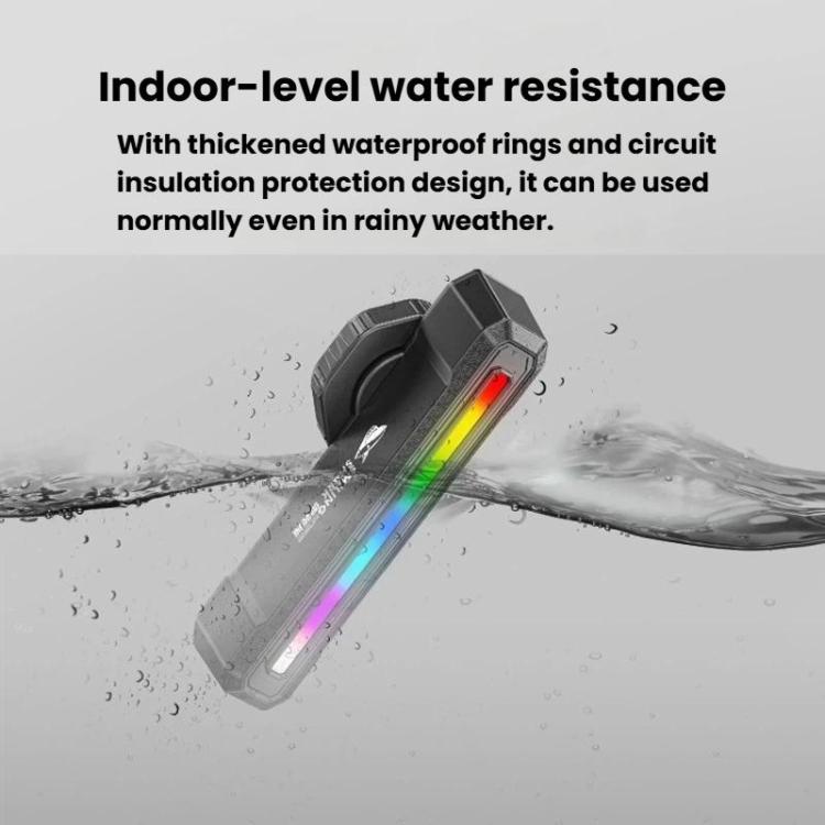 Black bike taillight with multi-color light bar against water splash