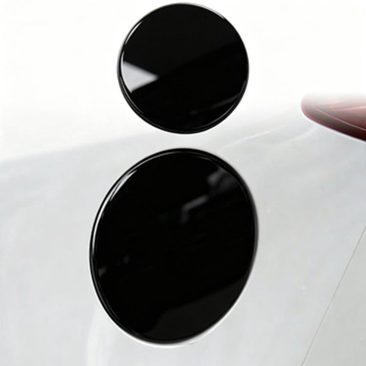Two black circular fuel tank cap stickers on car fuel area, side-by-side