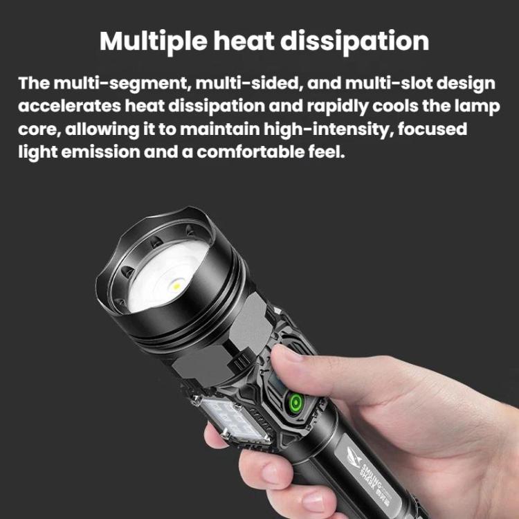 Black handheld flashlight in hand, angled head with focused front beam