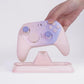 Pink controller charging dock with controller placed on the central cradle