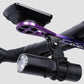 Purple extension base and black clamp holding a bike headlight on handlebars