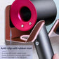 Rose gold circular dock and black rubber anti-slip mat on wall mount hair dryer holder.