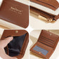 Brown compact zip card wallet close-up with zipper and inner card slots.