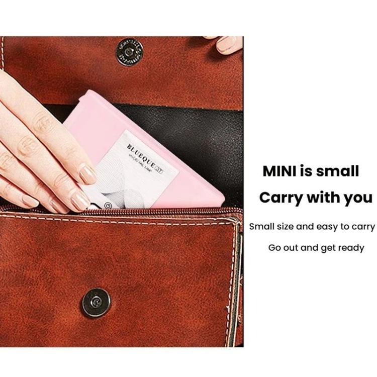 Compact pink folding LED nail curing lamp small enough to carry in a pouch