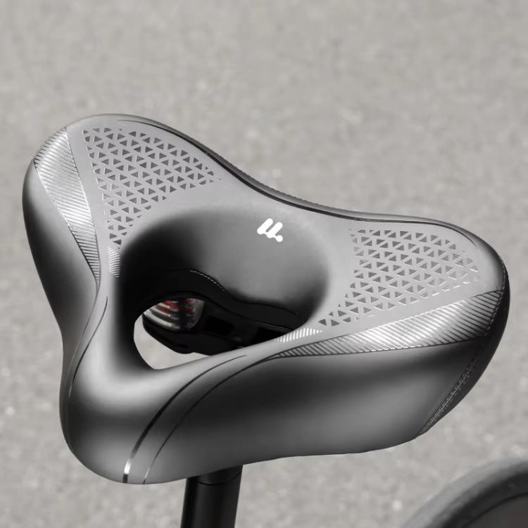 Black bike saddle underside view with center opening and spring support housing