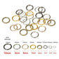 Assorted jump rings on a size guide, round metal loops in mixed tones