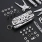 Silver multitool pliers keychain with included small screws and bits, close-up