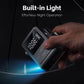 Black digital air pump inflator with built-in light glowing in dark setting while held