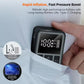 Black portable digital air pump inflator with screen visible while being hand-held to charge