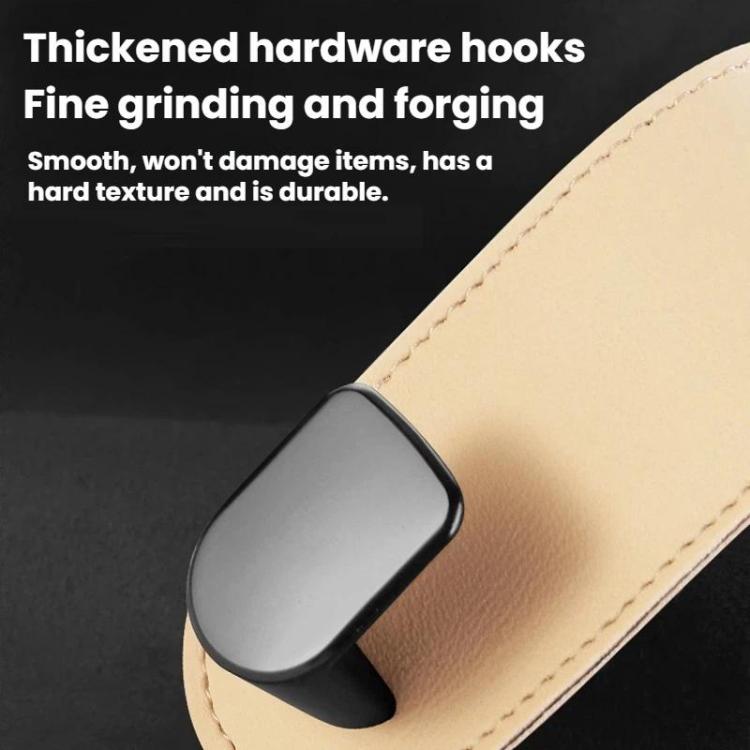 Metal hook attached to beige faux-leather strap on car interior organizer