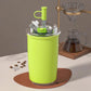 Green vacuum-insulated 300 ml coffee cup with flip straw and carry handle
