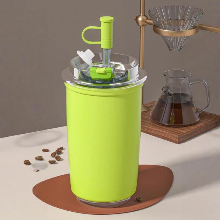 Green vacuum-insulated 300 ml coffee cup with flip straw and carry handle