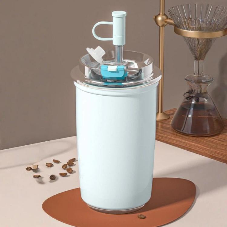 Light blue vacuum-insulated 300 ml coffee cup with flip straw and carry handle