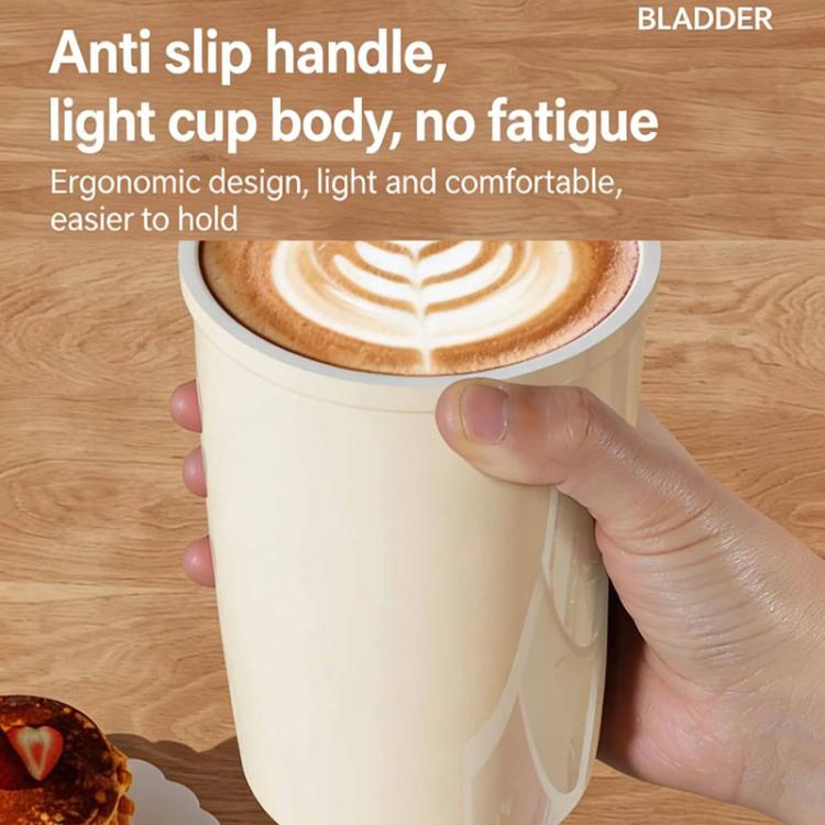 Cream vacuum-insulated 300 ml coffee cup with flip straw, held in hand